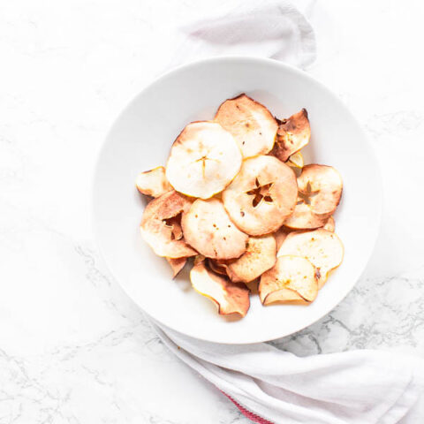 Air Fryer apple chips in white bowl