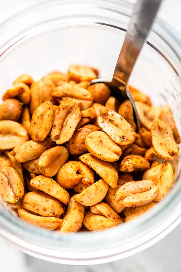 Roasted peanuts with taco seasoning in a glass jar. The peanuts are made in an Air Fryer in less than 15 minutes.