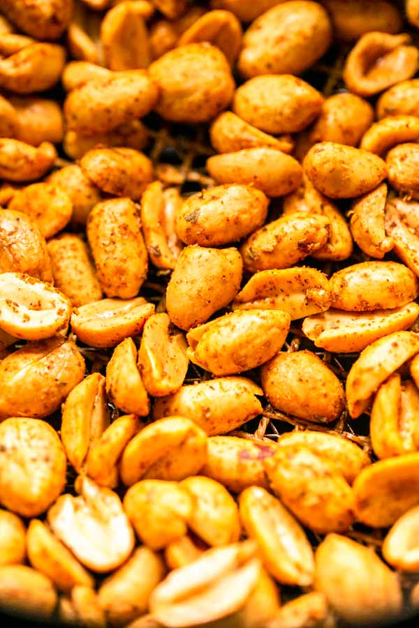 Close up of roasted Air Fryer peanuts. The peanuts are golden brown and crunchy and topped with taco seasoning.