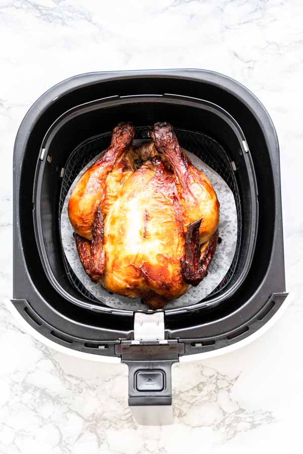 Yes, you can grill a whole chicken in an Air Fryer. This Air Fryer whole chicken recipe is great. Juicy chicken meat with crispy skin. A super easy recipe that you can serve for dinner.
