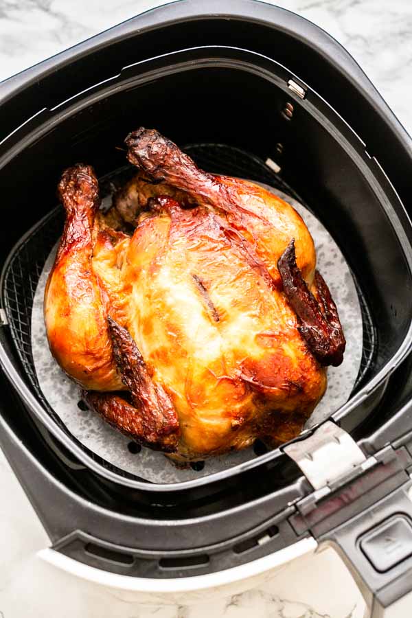 Yes, you can grill a whole chicken in an Air Fryer. This Air Fryer whole chicken recipe is great. Juicy chicken meat with crispy skin. A super easy recipe that you can serve for dinner.