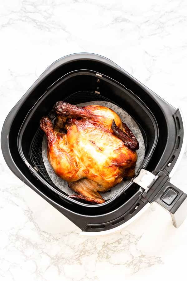 Yes, you can grill a whole chicken in an Air Fryer. This Air Fryer whole chicken recipe is great. Juicy chicken meat with crispy skin. A super easy recipe that you can serve for dinner.