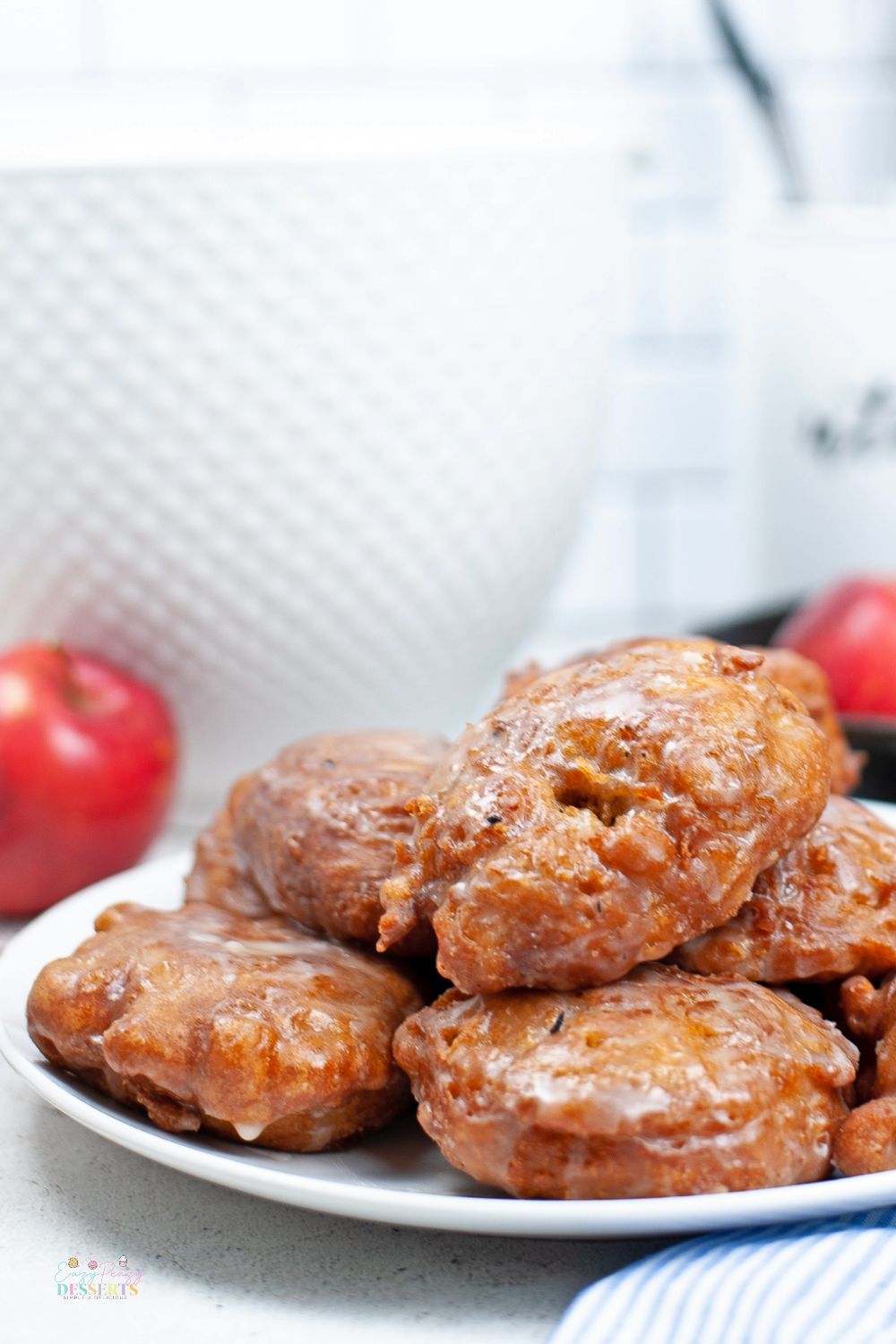 Close up image of apple fritters in a white serving plate