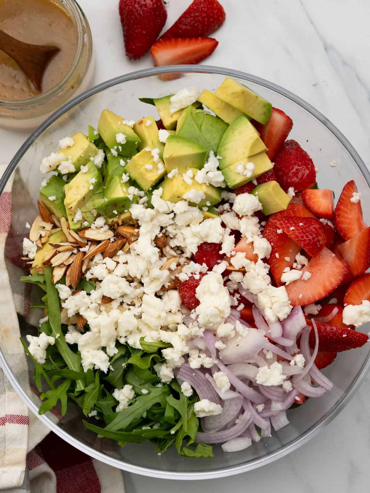 Strawberry salad with avocado, argula, red onion, topped with crumbled feta and toasted almonds.