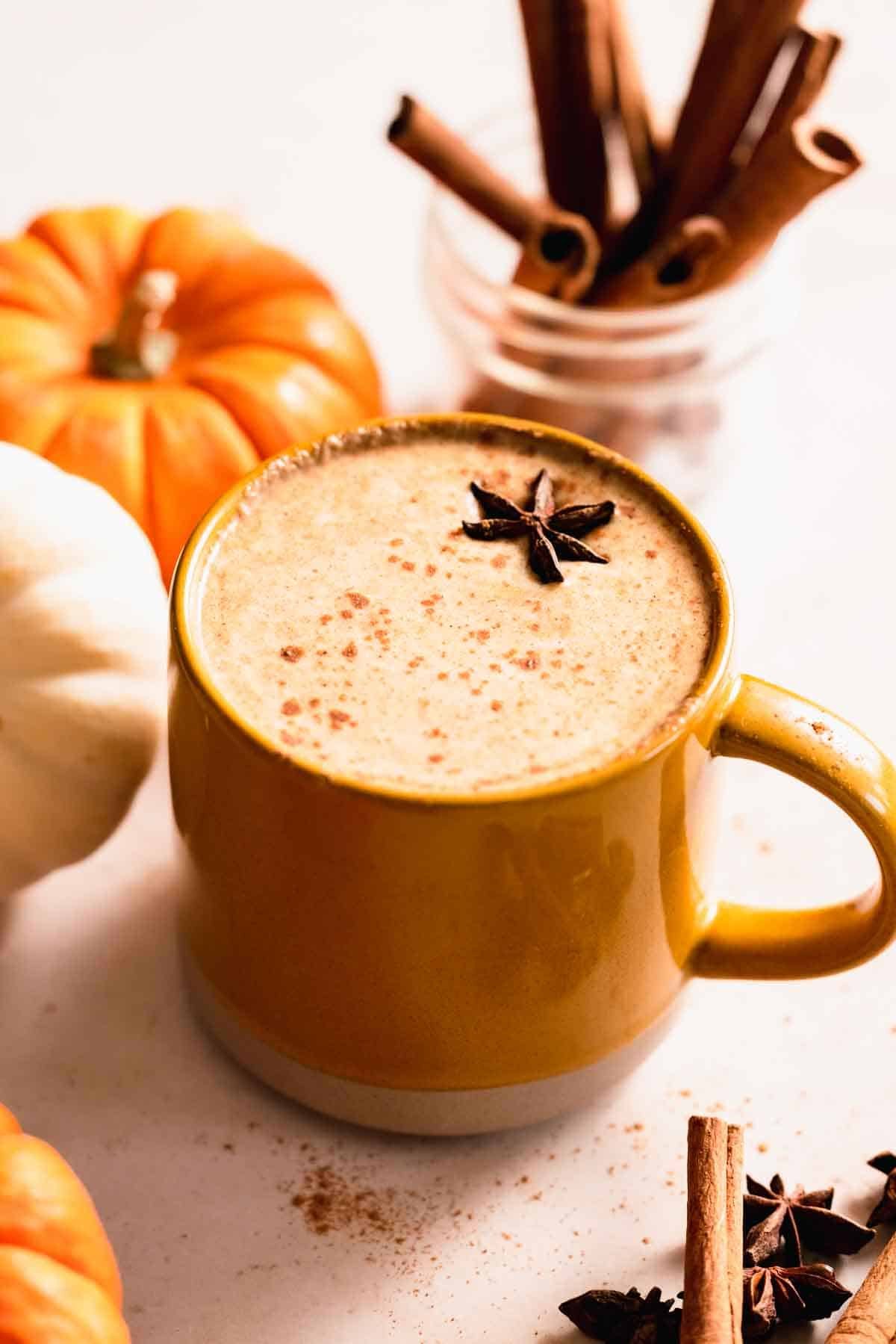 pumpkin chai latte in mug with star anise on top