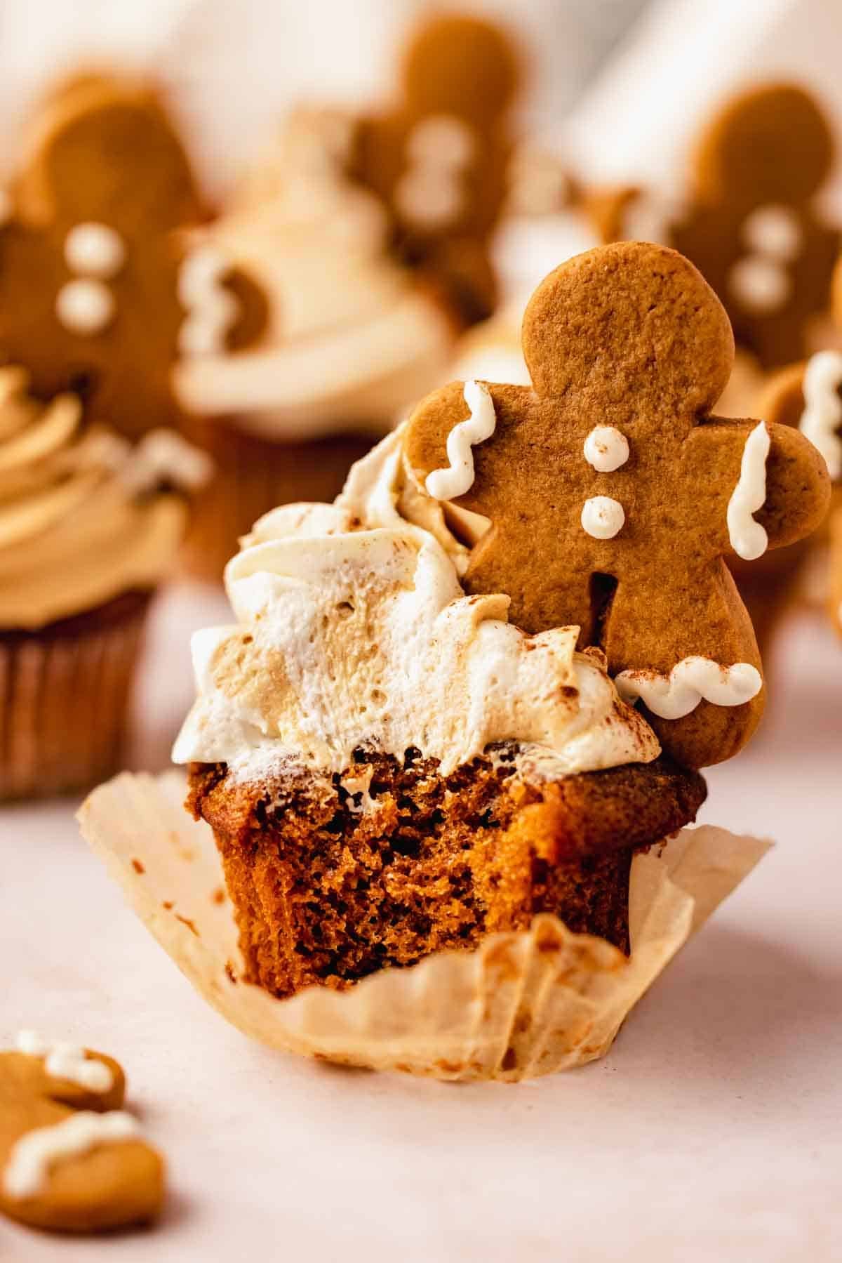 bitten gingerbread cupcake with frosting and mini frosted gingerbread man cookie