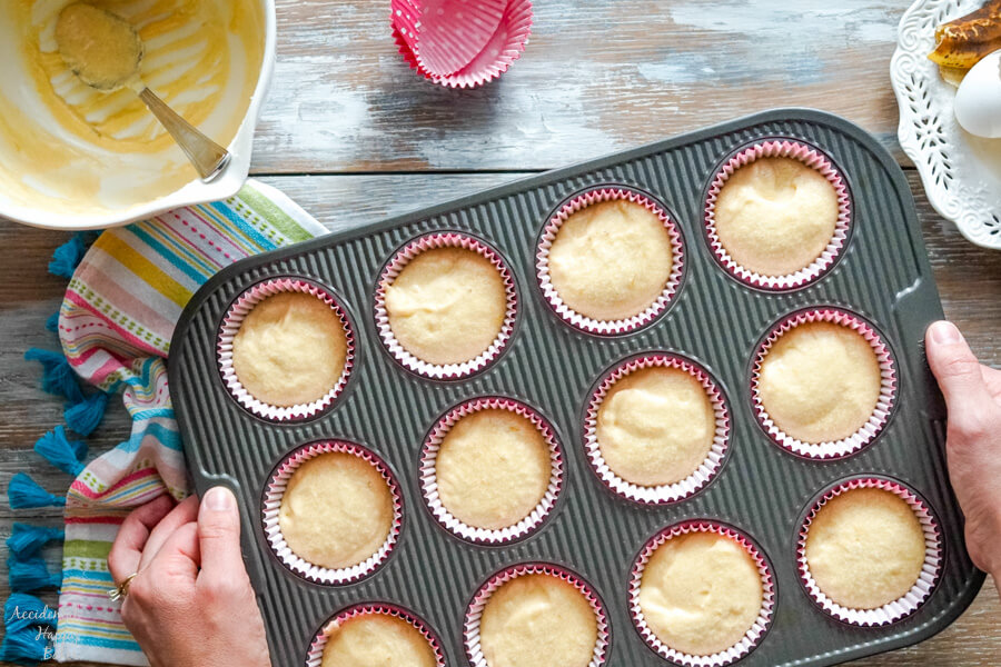 After the cake batter has been spooned into the cupcake liners and is getting ready to go into the oven. 