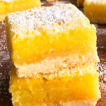 Stack of Best Easy Lemon Bars on Wood Background.