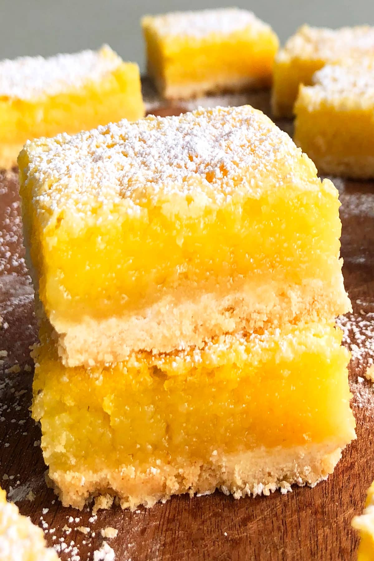 Stack of Best Easy Lemon Bars on Wood Background. 