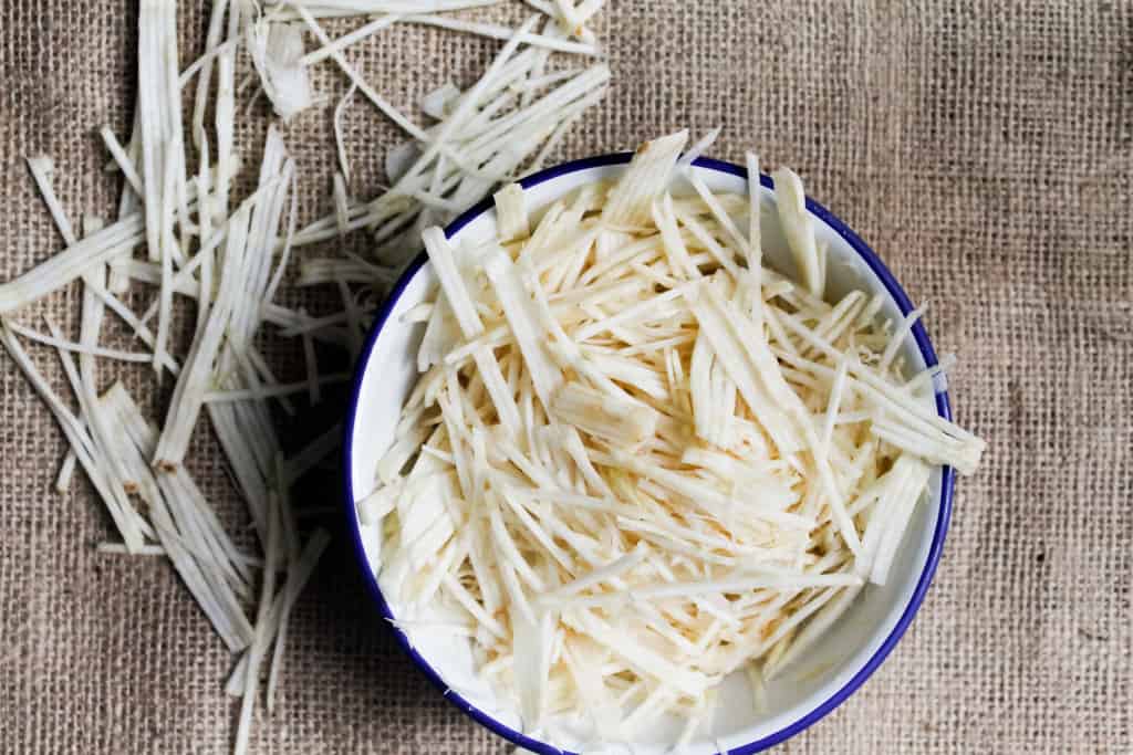 Studded with dried cranberries and pepitas & covered in a beautiful, tangy sauce, these endive spears with celery root remoulade are a great GF appetizer. Gluten-free, paleo, vegan option.