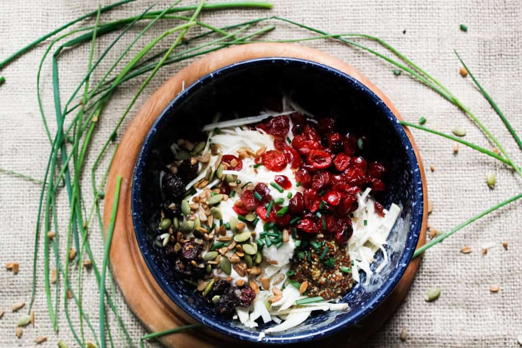 Studded with dried cranberries and pepitas & covered in a beautiful, tangy sauce, these endive spears with celery root remoulade are a great GF appetizer. Gluten-free, paleo, vegan option.