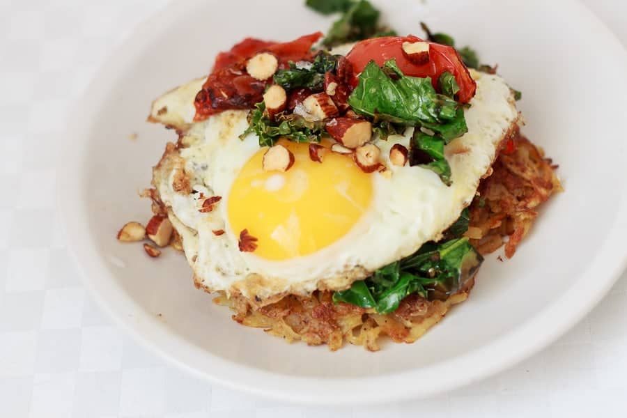 Potato latke topped with egg, kale, tomatoes and Tamari almonds