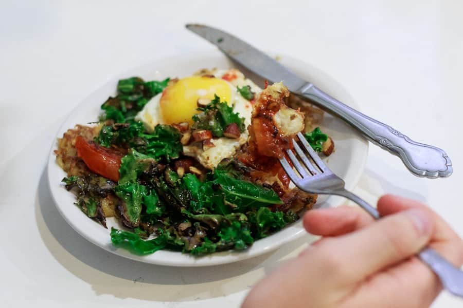 Potato latke topped with egg, kale, tomatoes and Tamari almonds