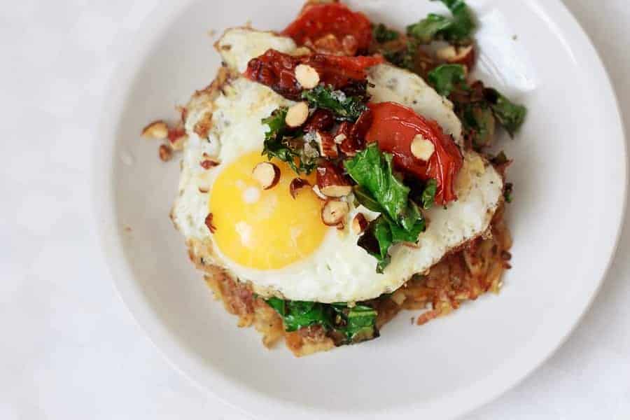 Potato latke topped with egg, kale, tomatoes and Tamari almonds
