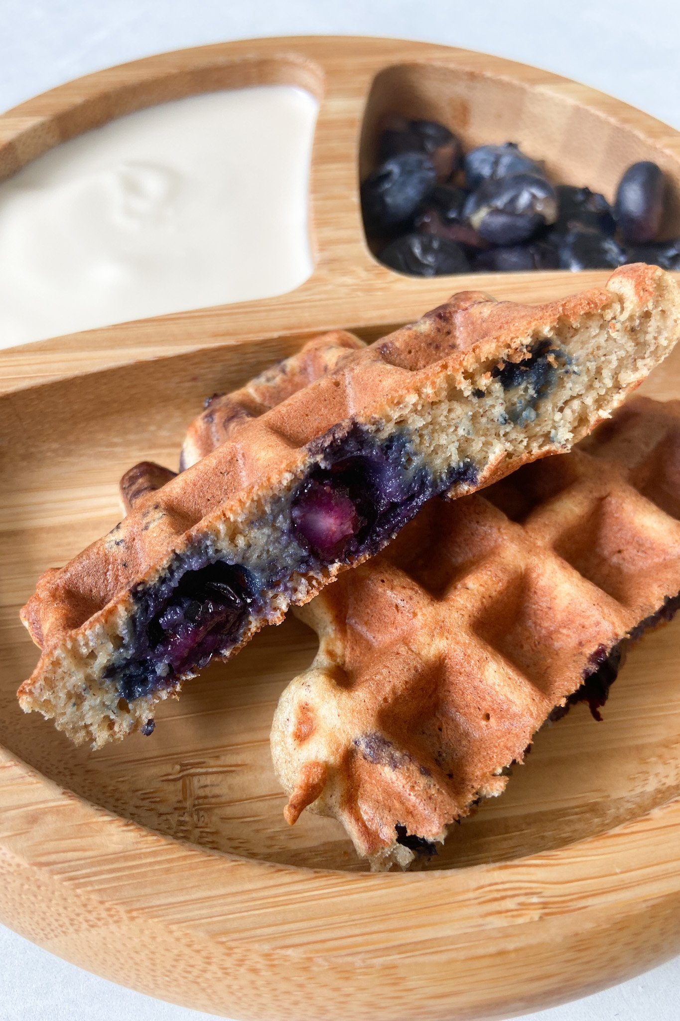 Blueberry banana waffles served with yogurt and a side of blueberries