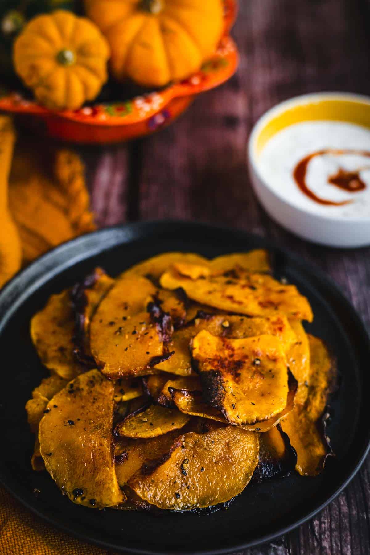 butternut squash chips on a plate with dipping sauce.