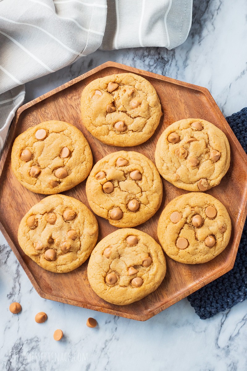 seven butterscotch chip cookies on a wooden octagon plate 