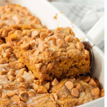 Slice of butterscotch pumpkin cake in pan with spatula.