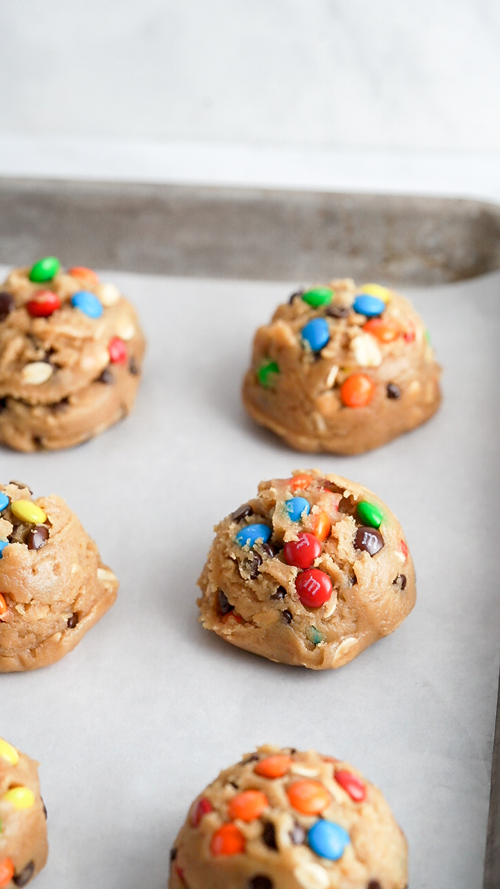 Monster cookie scoops on baking pan