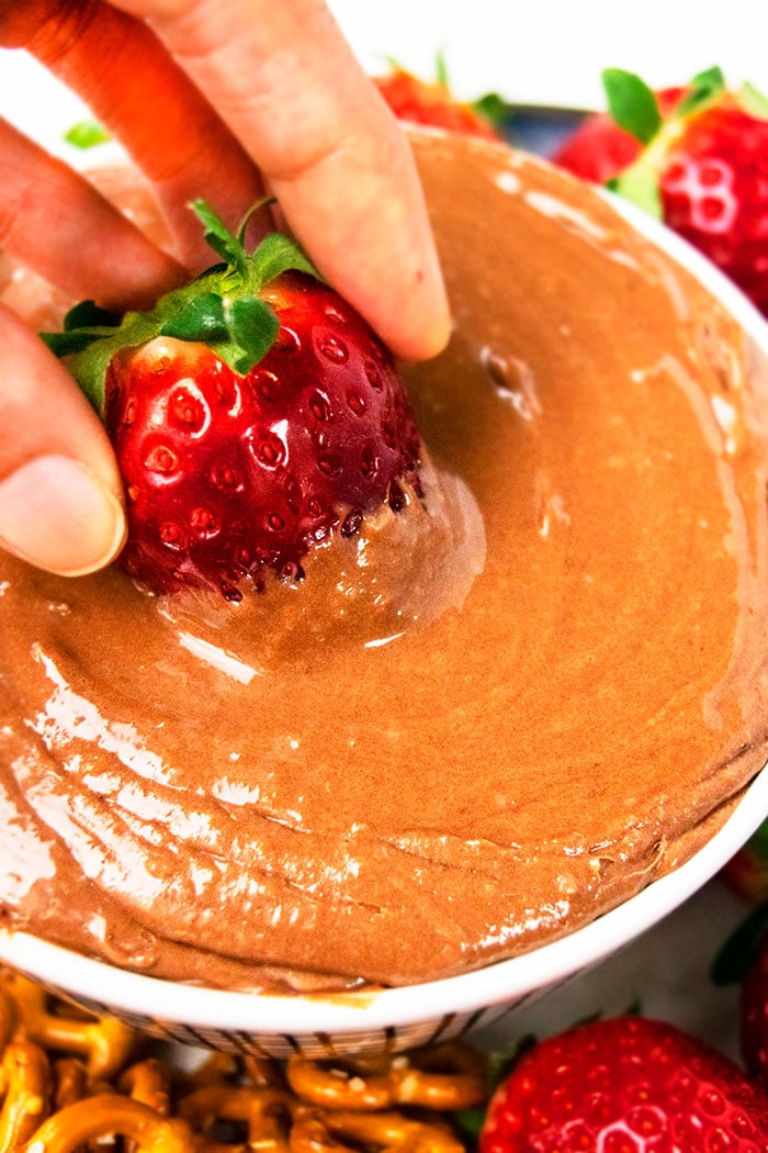 No Bake Chocolate Fruit Dip- Closeup Shot of Strawberry Being Dipped