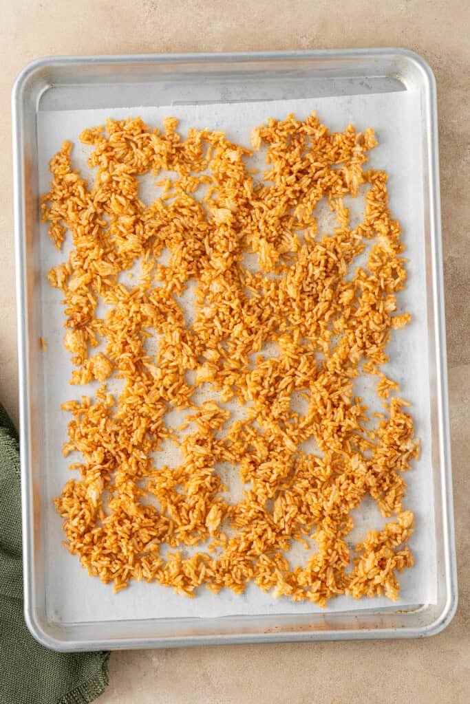 The seasoned rice on a baking tray.