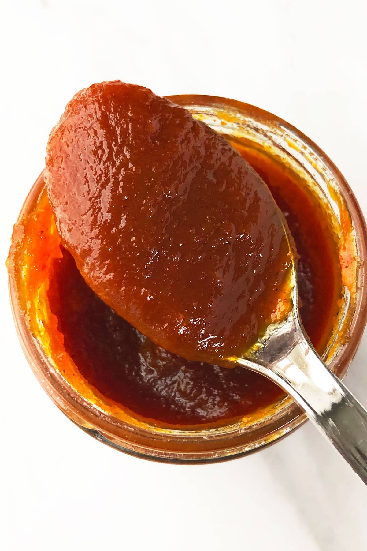 Spoonful of Spiced Butter on Top of Glass Jar. 