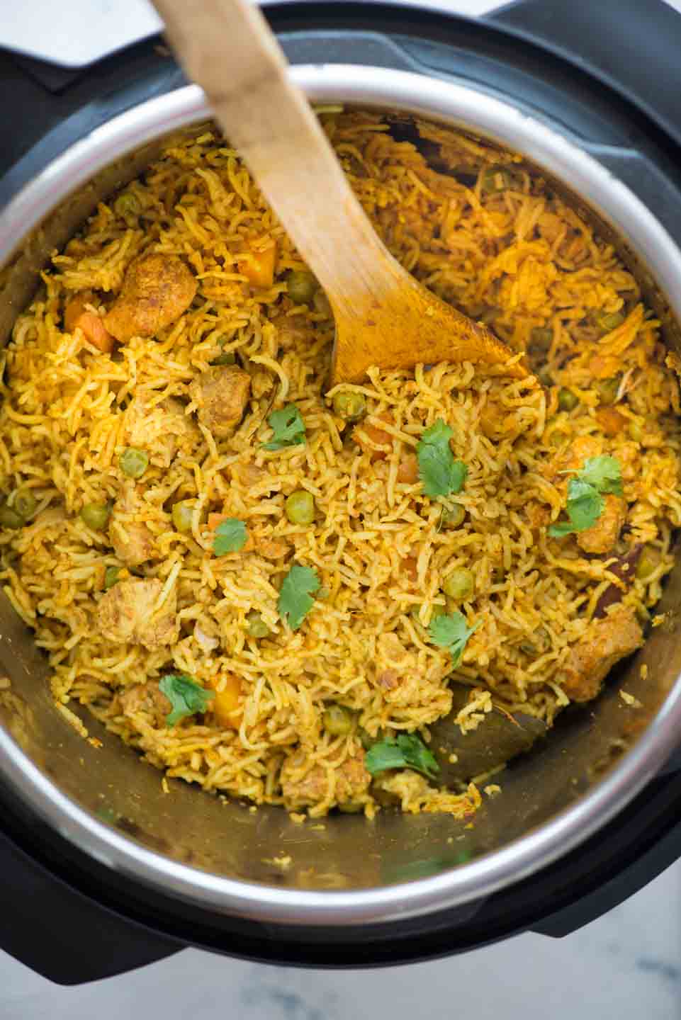 Instant Pot Chicken and rice, curried chicken and rice made in the Instant Pot is flavoured with garlic, ginger and curry powder. Fluffy basmati rice, chicken, carrot, peas, this wholesome meal is definitely going to impress you.
