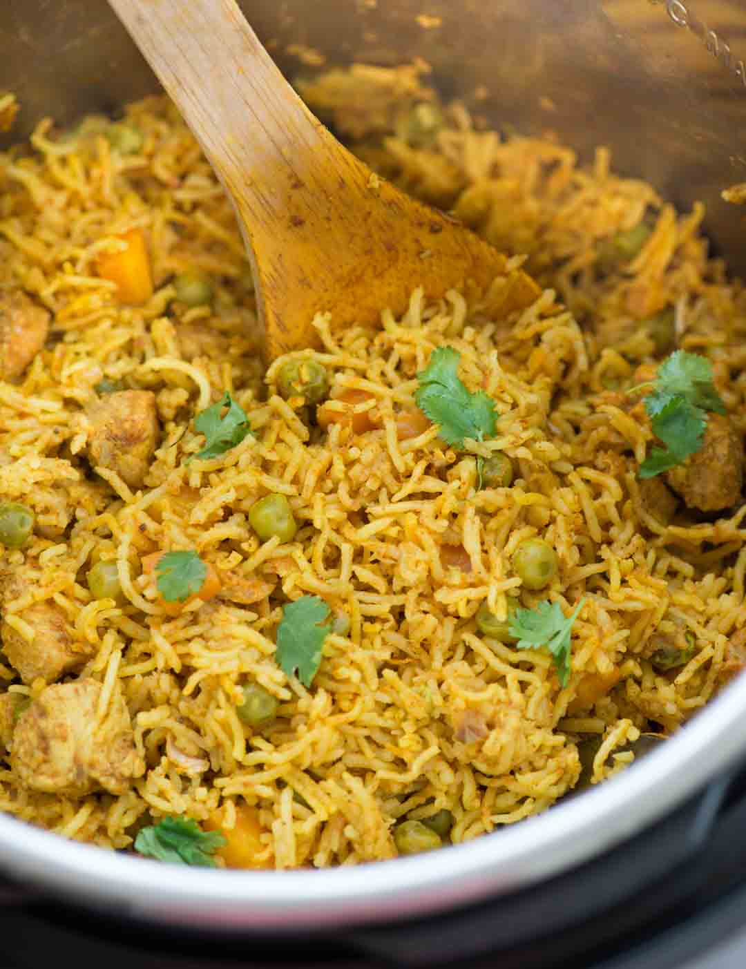 Instant Pot Chicken and rice, curried chicken and rice made in the Instant Pot is flavoured with garlic, ginger and curry powder. Fluffy basmati rice, chicken, carrot, peas, this wholesome meal is definitely going to impress you.