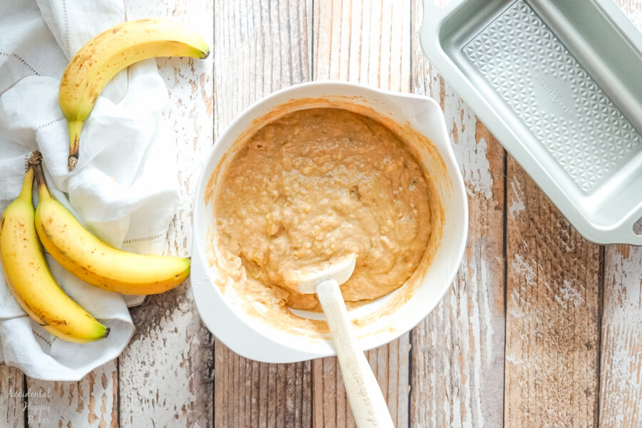 A bowl of banana bread batter before stirring in the chocolate chunks. 