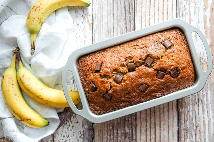 The loaf pan full of banana bread fresh from the oven. 
