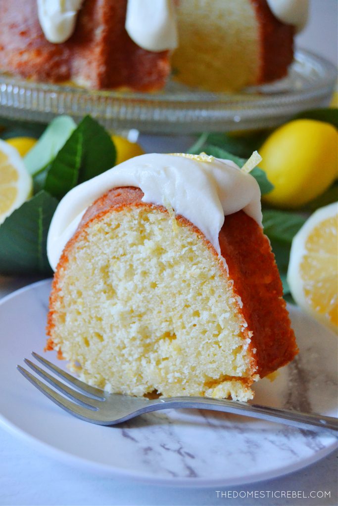 Lemon bundt cake on marble plate with silver fork