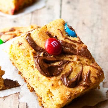 Slices of Easy Cake Mix Cookie Bars on Rustic Wood Background.