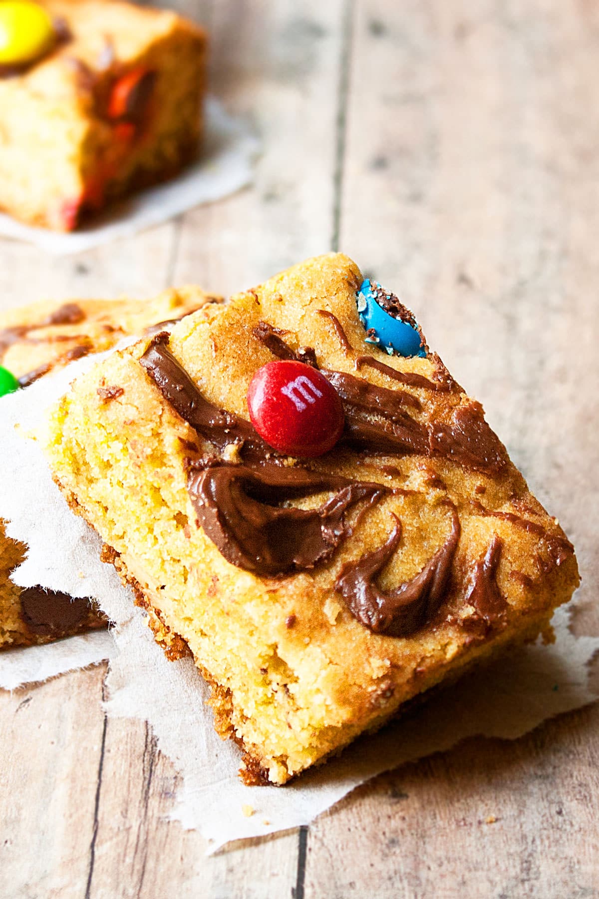 Slices of Easy Cake Mix Cookie Bars on Rustic Wood Background.