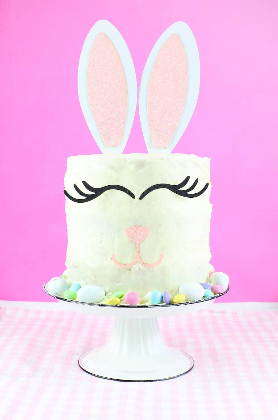 easy easter bunny cake on cake stand with pink background