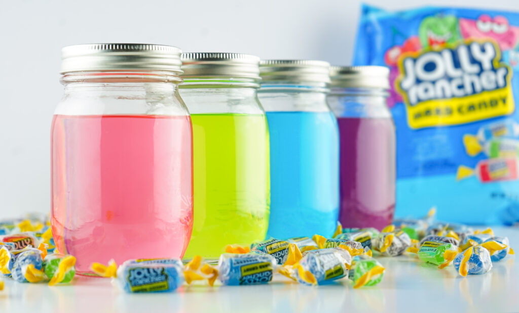 jolly rancher vodka in mason jars on white table