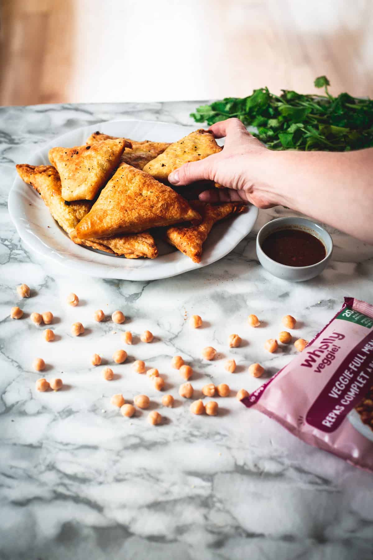 taking samosa from table