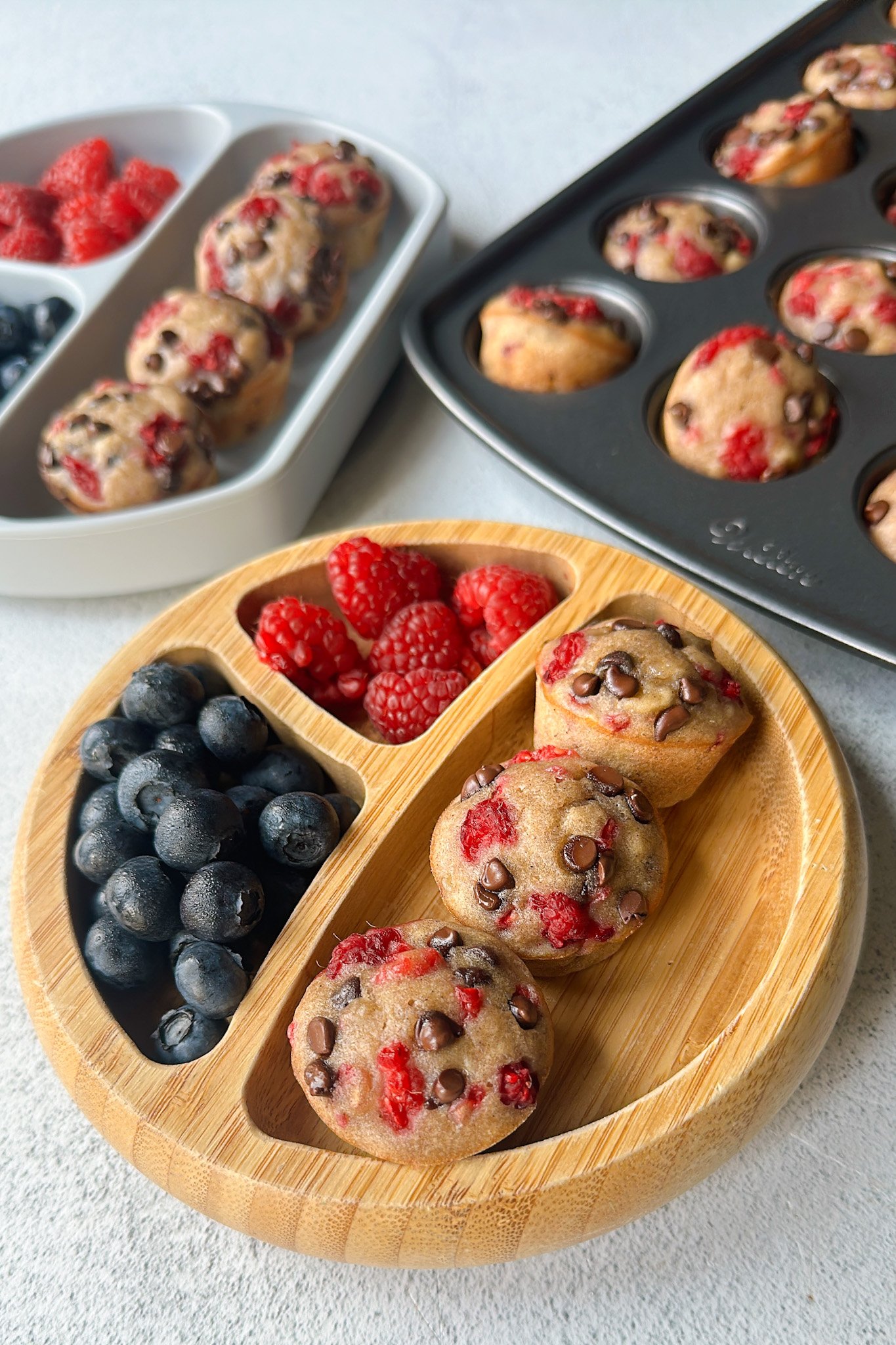 Raspberry banana muffins served with berries.