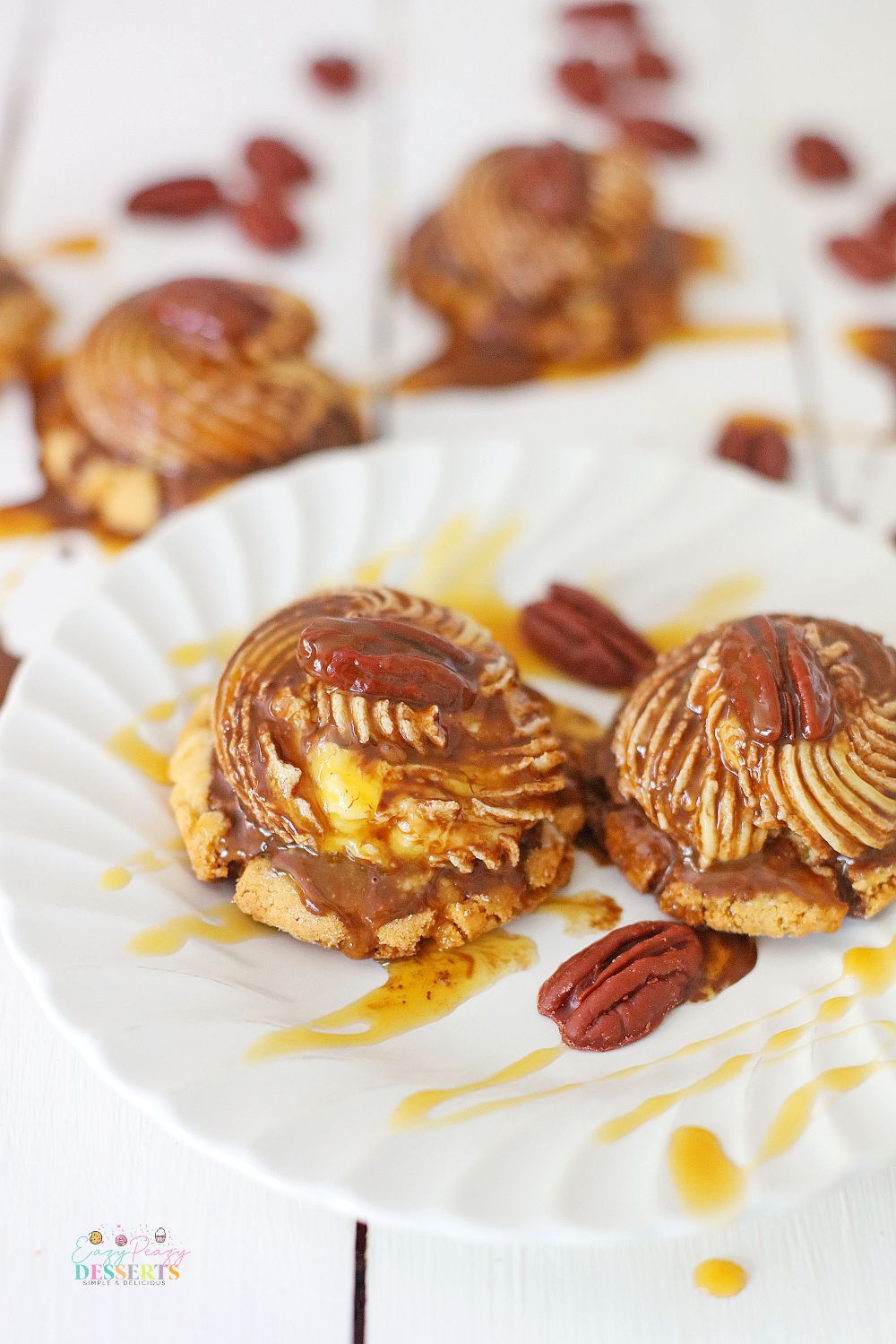 A couple of turtle cookies drizzled with caramel and chocolate sauce