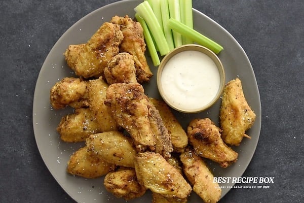 Chicken wings on plate with ranch and celery