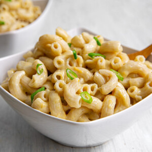 The Green Chile mac & cheese in a white bowl with a spoon in it.