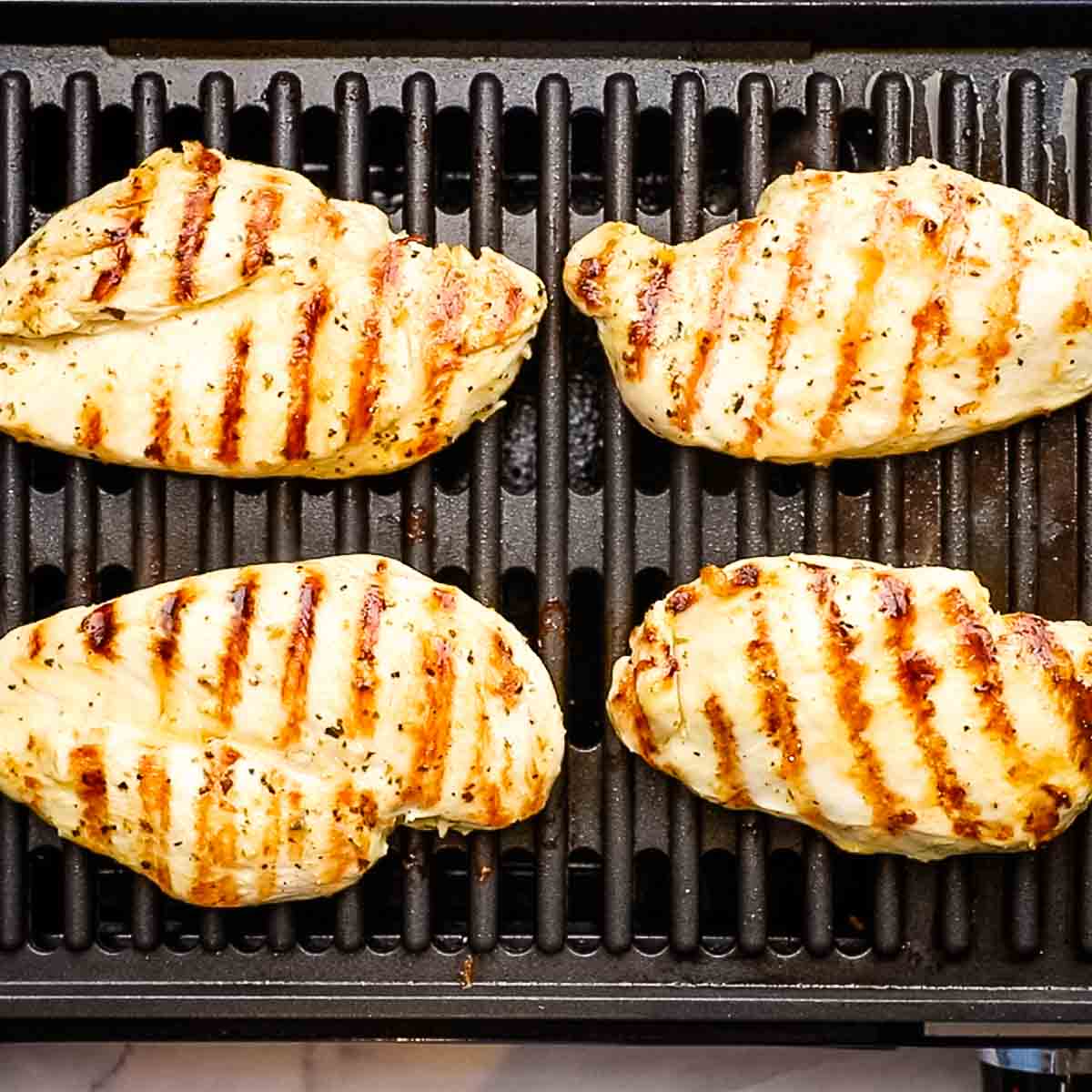 chicken breats cooking on the grill