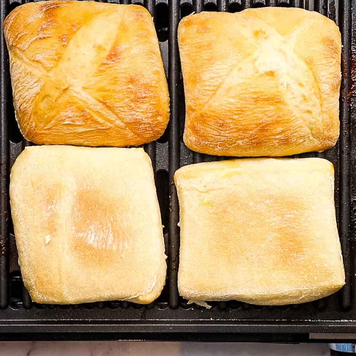 warming up the ciabatta rolls on the grill