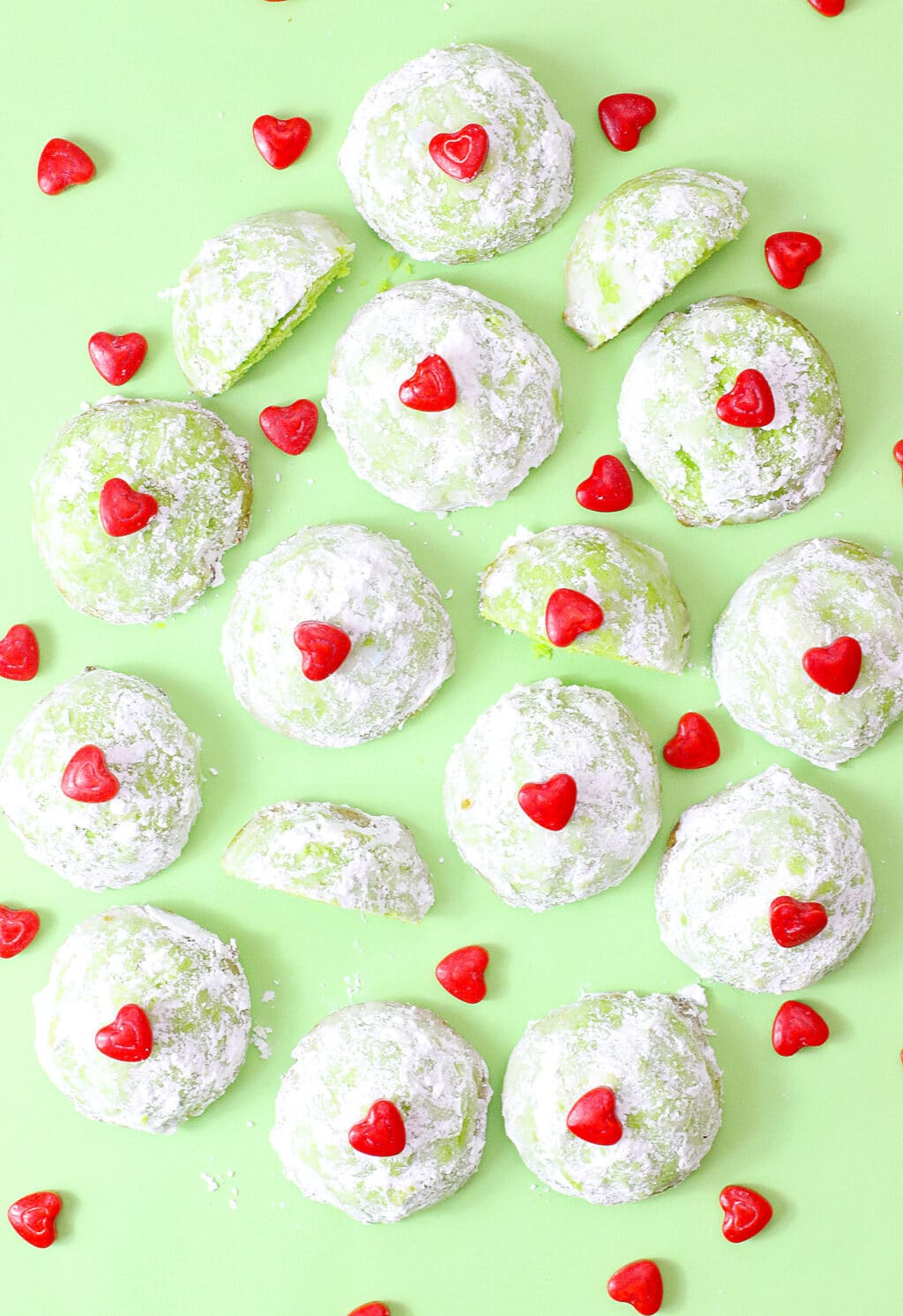 grinch snowball cookies on green background