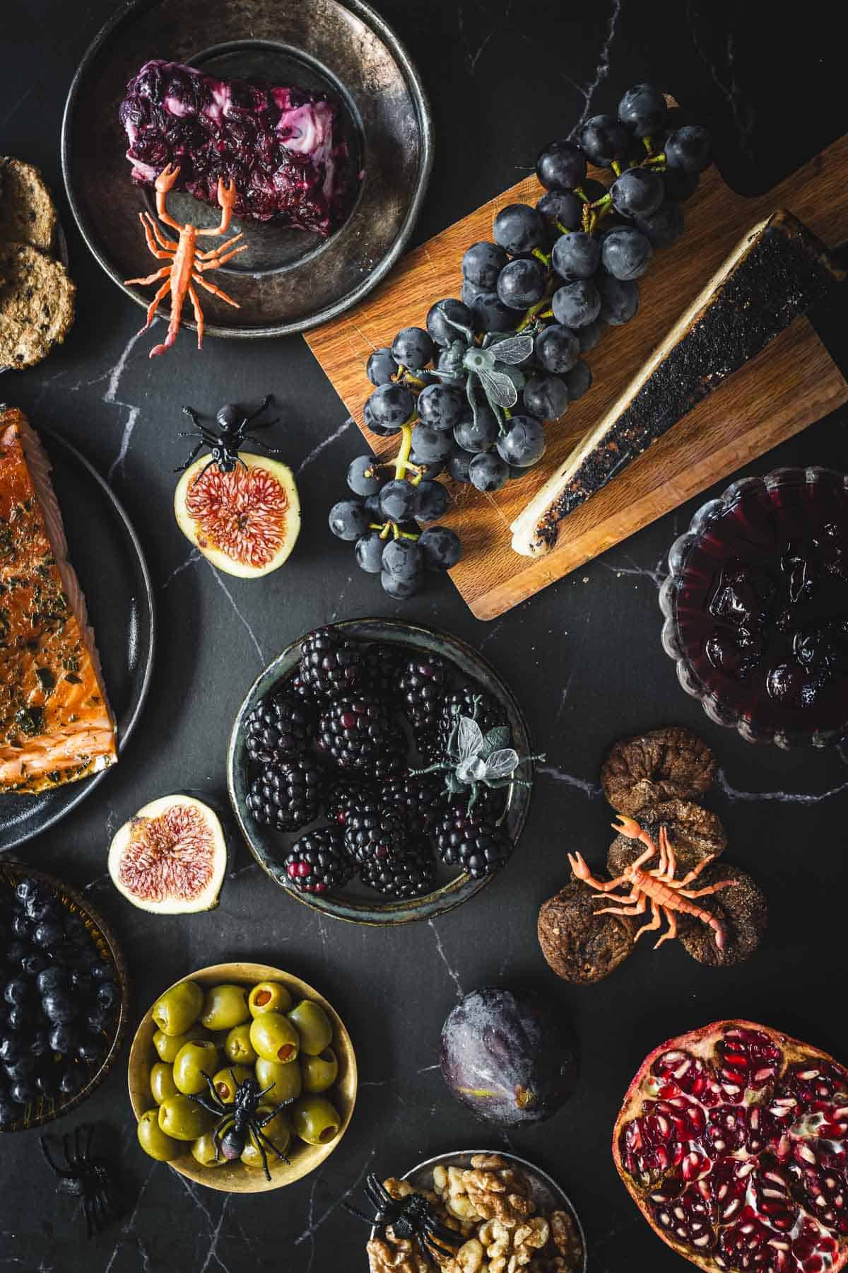 A variety of fruits and vegetables on a black background. Ingredients with the halloween grazing board.