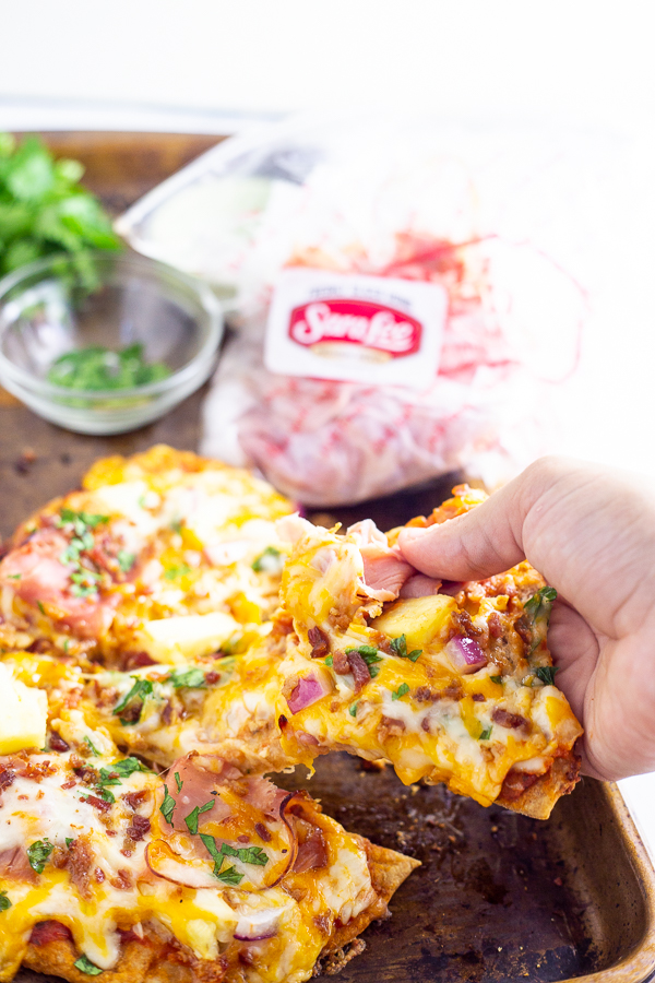 This Flatbread Hawaiian Pizza is quick, easy, and totally delicious! An addicting tangy, salty sweet combination with ham, pineapple, cheese, and a little bacon for good measure. 