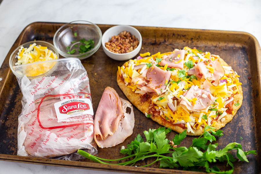 This Flatbread Hawaiian Pizza is quick, easy, and totally delicious! An addicting tangy, salty sweet combination with ham, pineapple, cheese, and a little bacon for good measure. 