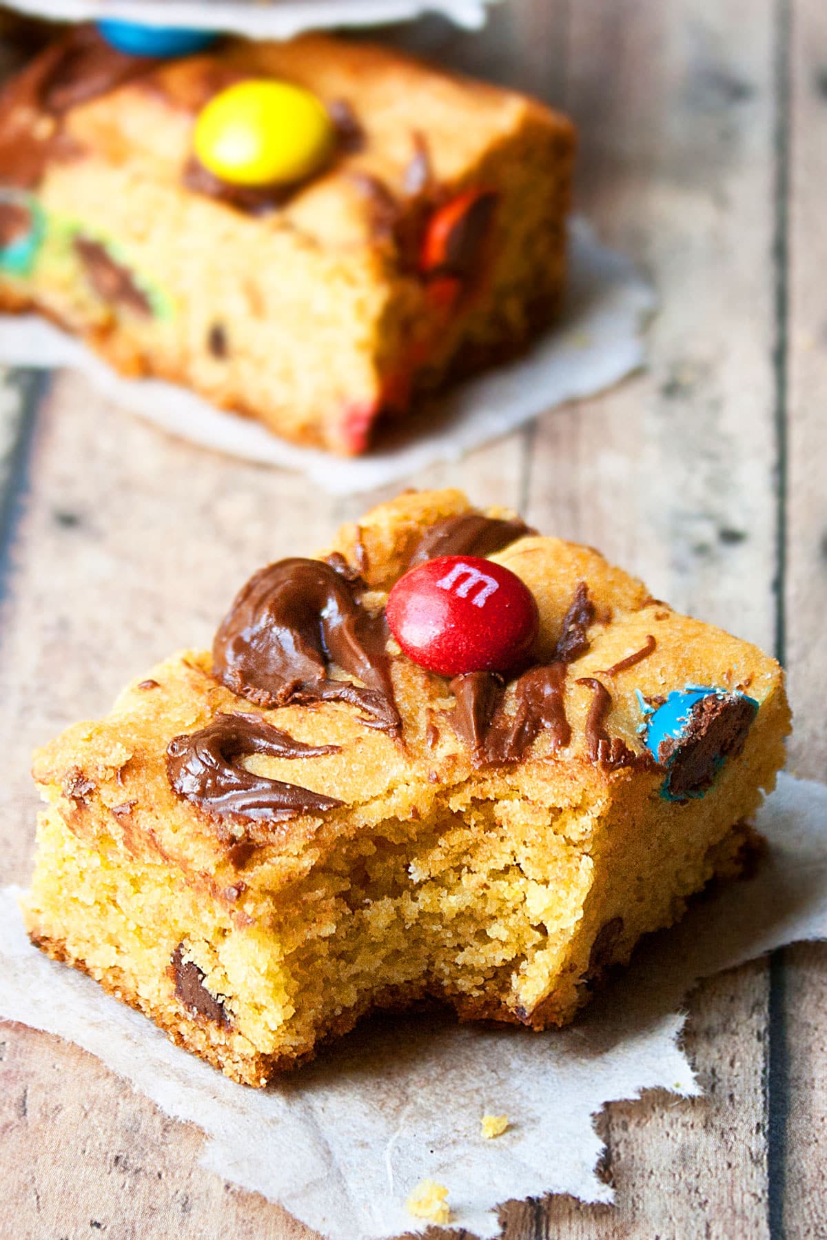 Partially Eaten Dessert Bar on Rustic Wood Background.