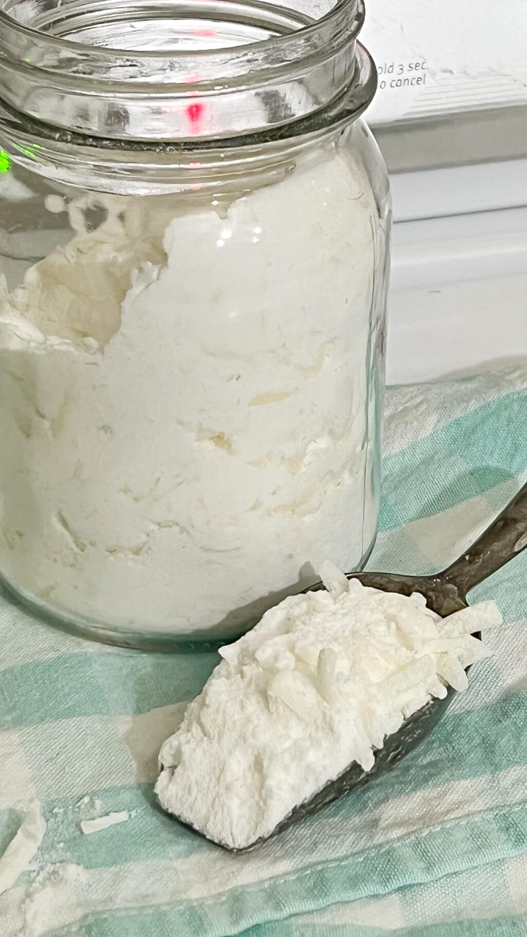 jar of homemade laundry detergent with scoop
