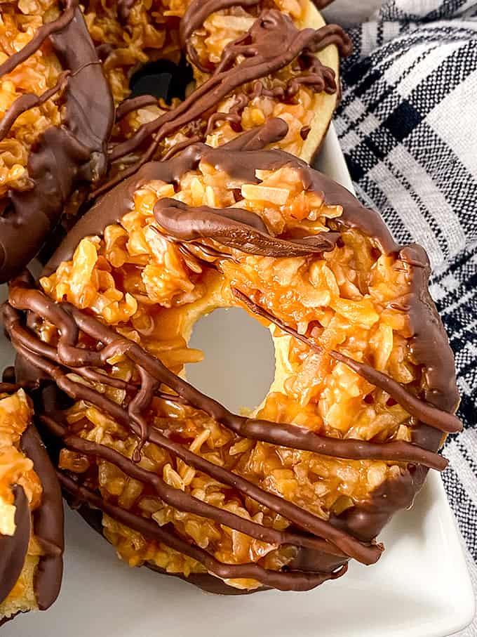 A plate of homemade Samoas - donuts covered in chocolate and caramel.