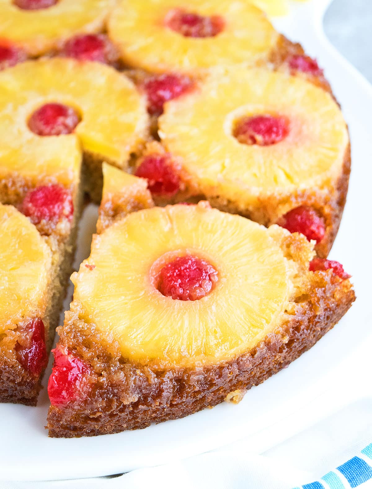 Closeup shot of slice of cake on white serving dish. 